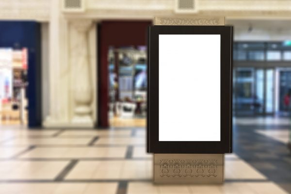 Emptyportrait digital signage with blurred mall background. Ideal for digital advertisement, information board, mall ads, video wall and large posters for campaigns